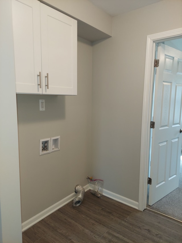 laundry area featuring dark wood finished floors, hookup for a washing machine, cabinet space, and baseboards