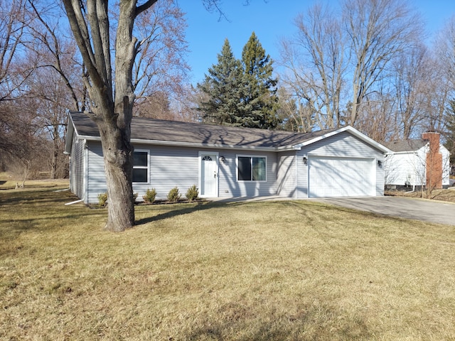 ranch-style house featuring driveway, an attached garage, and a front lawn