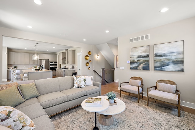 living room with visible vents, recessed lighting, and light wood-style floors