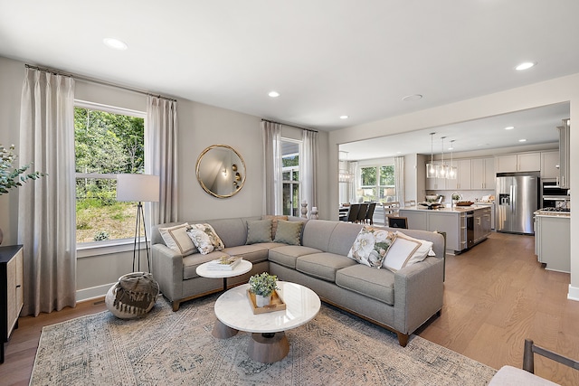 living area with recessed lighting, light wood-style flooring, and a healthy amount of sunlight