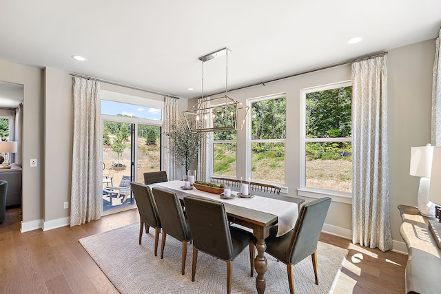 dining area with recessed lighting, a notable chandelier, baseboards, and light wood-style floors