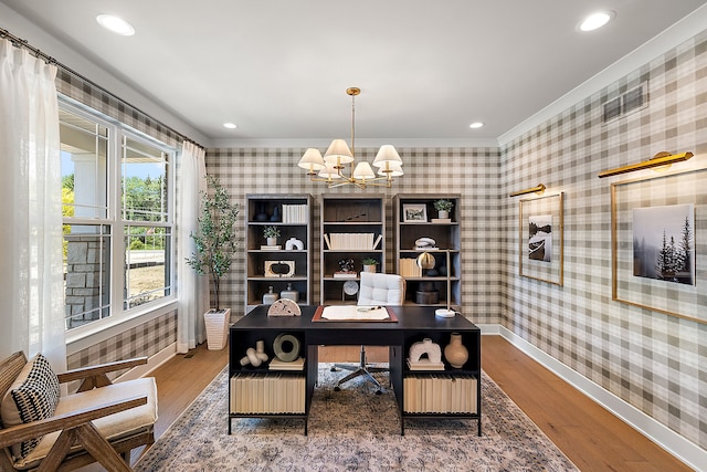 home office featuring wallpapered walls, an inviting chandelier, and wood finished floors