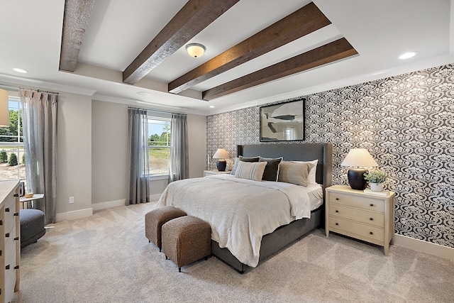 bedroom with beam ceiling, light colored carpet, wallpapered walls, and baseboards