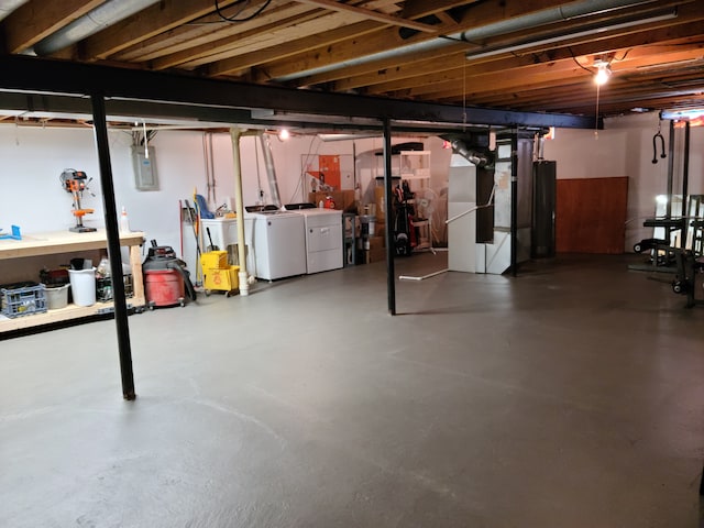 unfinished basement with electric panel and washer and clothes dryer