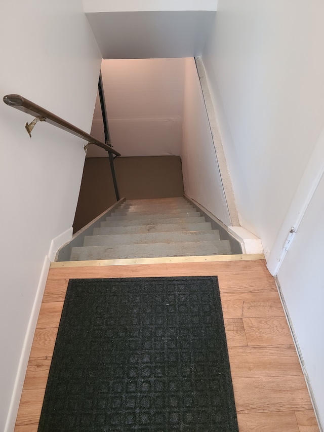 staircase with wood finished floors