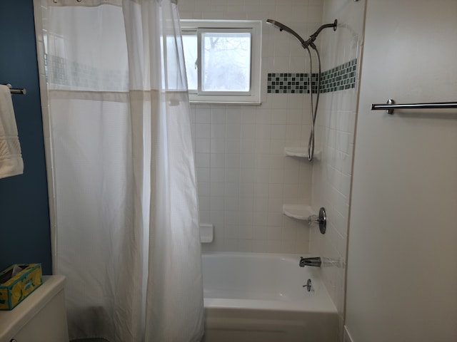 bathroom with shower / tub combo with curtain and toilet