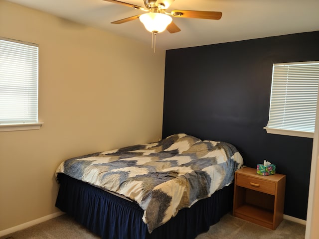 bedroom featuring carpet flooring, a ceiling fan, and baseboards