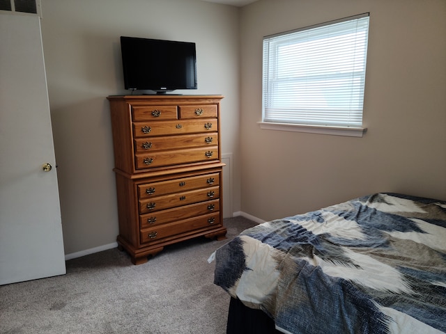 carpeted bedroom with visible vents and baseboards