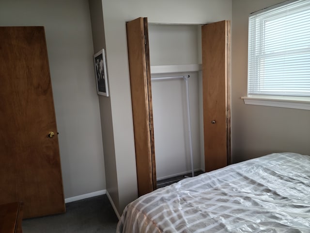 bedroom featuring a closet and baseboards