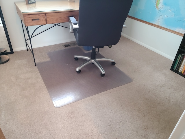 carpeted office featuring visible vents and baseboards