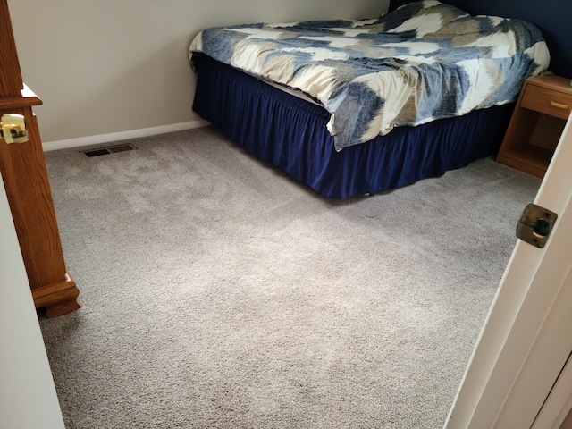 bedroom with baseboards, visible vents, and carpet floors