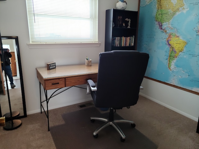 carpeted office featuring baseboards and visible vents