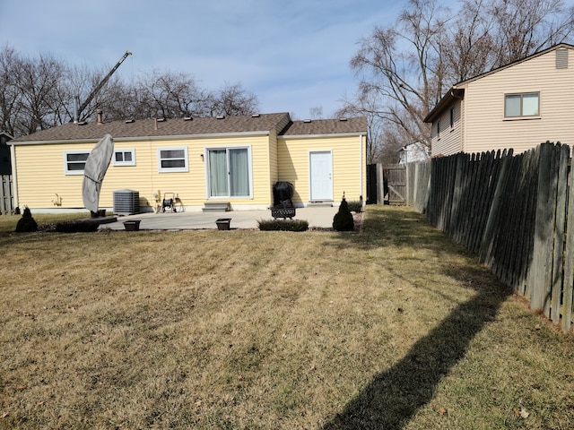 back of house featuring a patio area, central air condition unit, a yard, and a fenced backyard