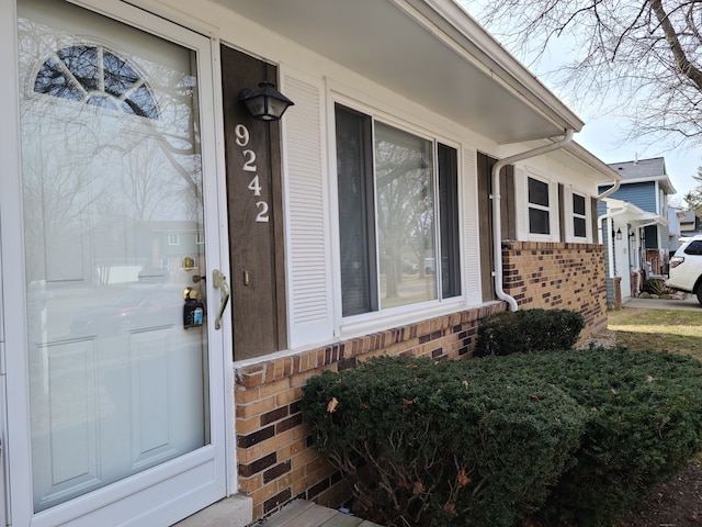 property entrance with brick siding