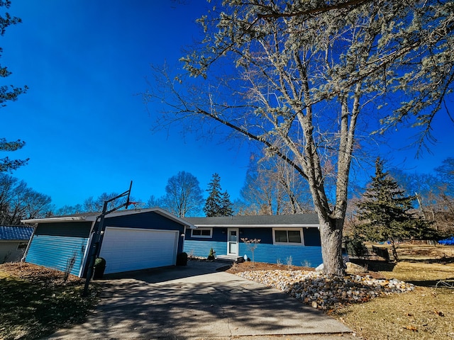 single story home featuring an attached garage and concrete driveway