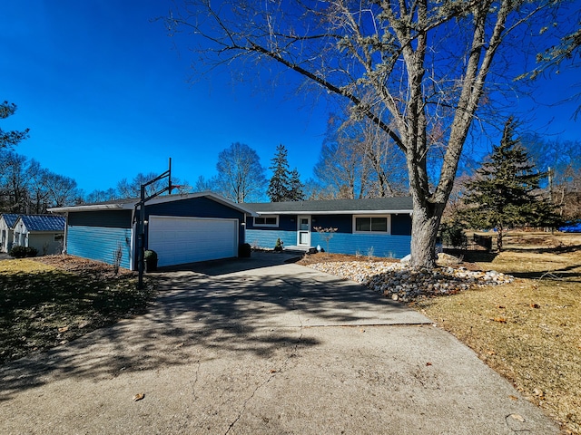 ranch-style home with driveway and an attached garage