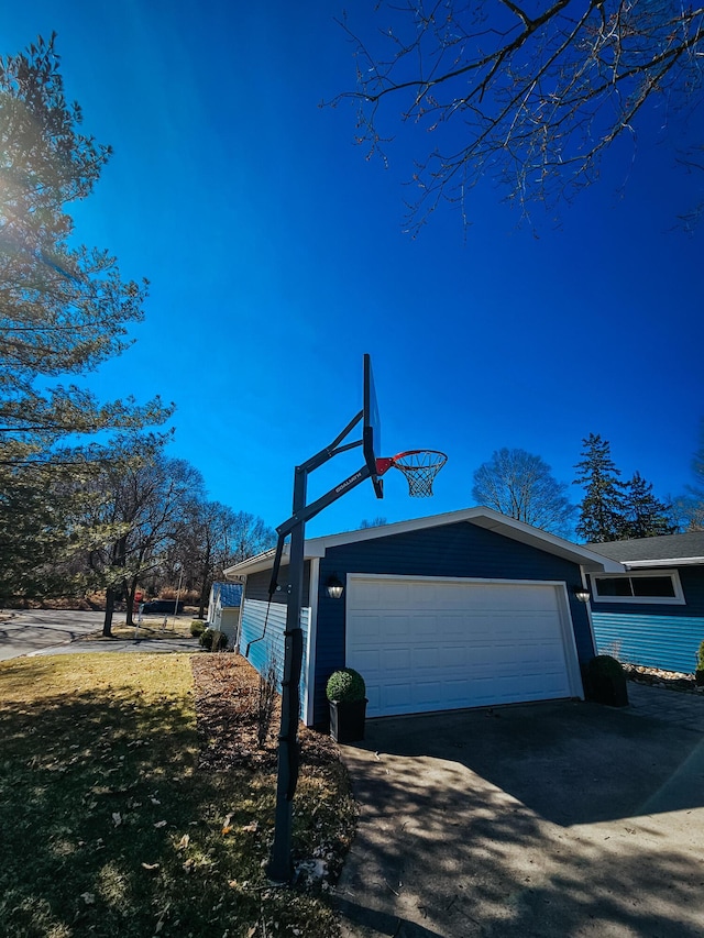 view of side of home with an attached garage and driveway