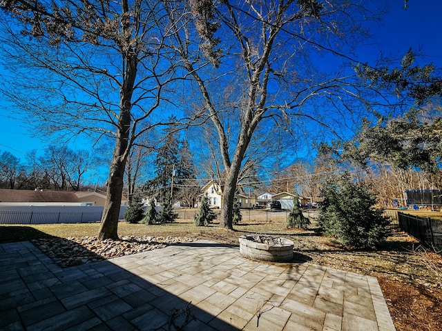 view of patio featuring a fenced backyard and a fire pit