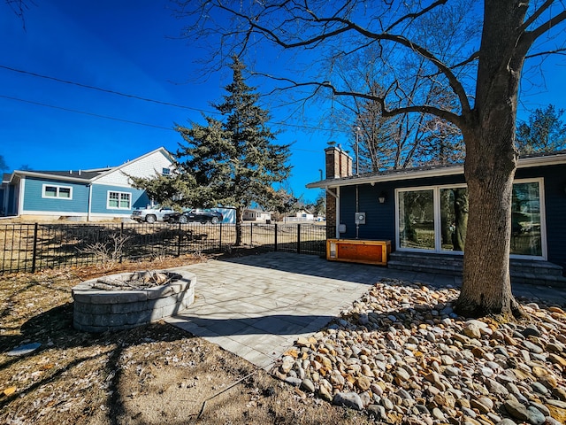 exterior space featuring entry steps, a fire pit, and fence