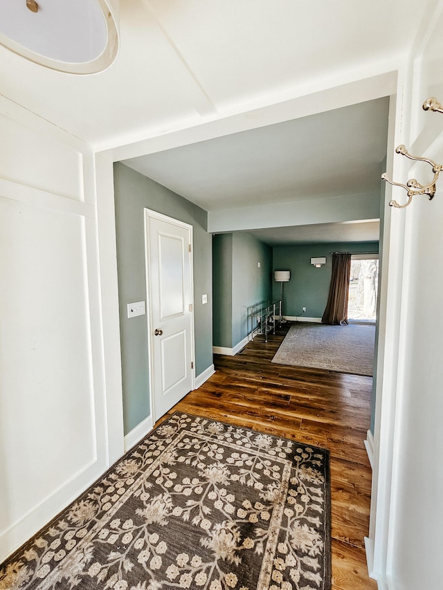 interior space with baseboards and wood finished floors