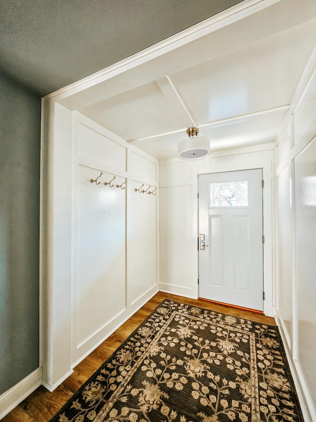 entryway with baseboards and wood finished floors