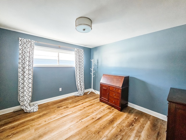 interior space featuring baseboards and wood finished floors