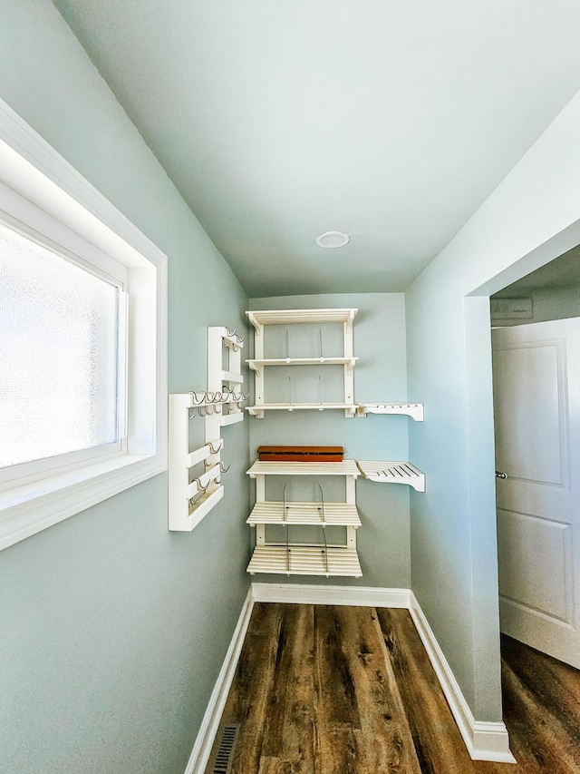 interior space with visible vents, baseboards, and wood finished floors