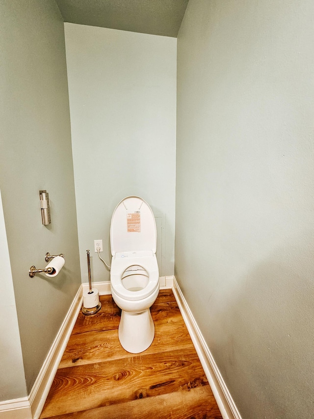 bathroom with baseboards and wood finished floors