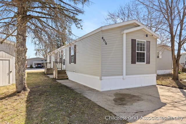 view of side of property with an outdoor structure and a shed