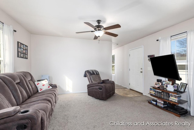 carpeted living area featuring ceiling fan