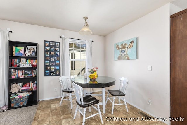 dining room featuring visible vents and baseboards