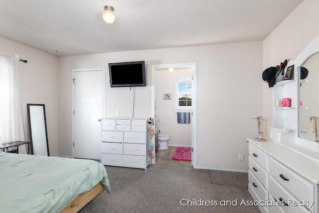 bedroom featuring baseboards, carpet floors, and connected bathroom