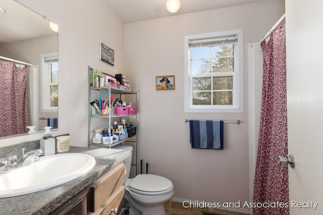 bathroom with vanity, tile patterned floors, toilet, and a shower with curtain