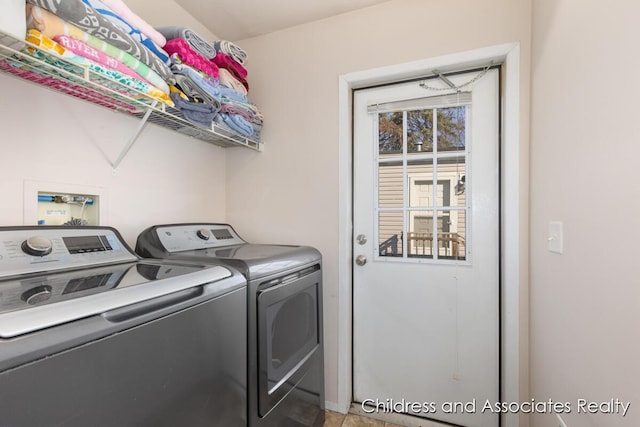 clothes washing area featuring independent washer and dryer and laundry area