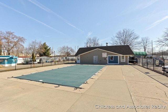 pool with a patio and fence