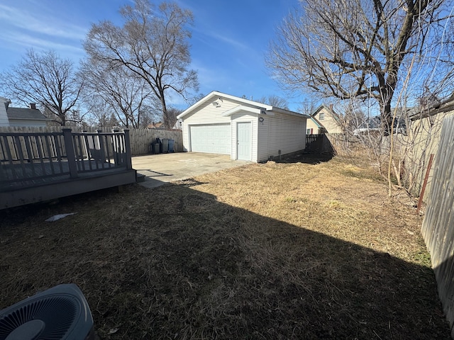 view of yard featuring an outbuilding, a patio area, a wooden deck, and a fenced backyard