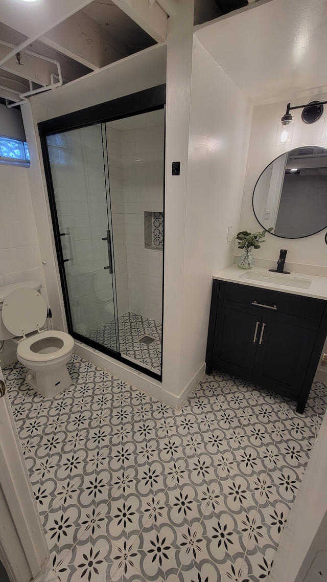 full bath featuring tile patterned flooring, a shower stall, toilet, and vanity