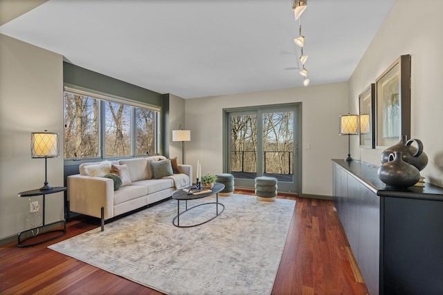 living area with dark wood-style floors and baseboards