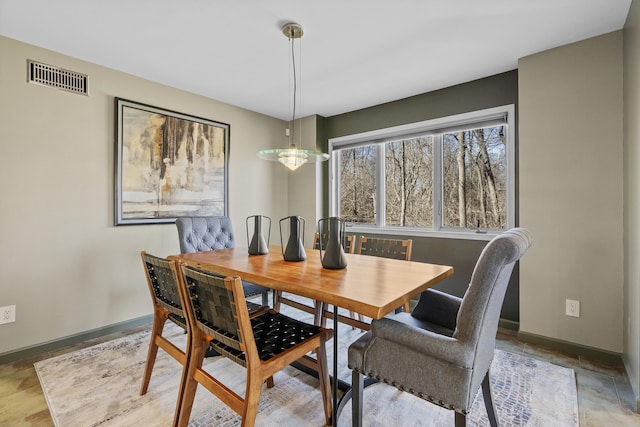 dining space featuring baseboards and visible vents