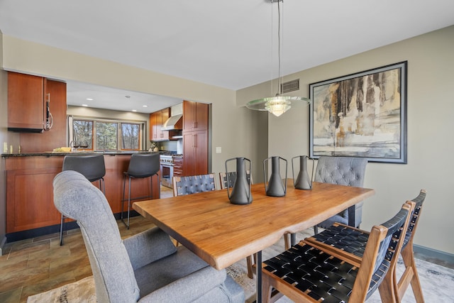 dining space featuring visible vents and stone finish flooring