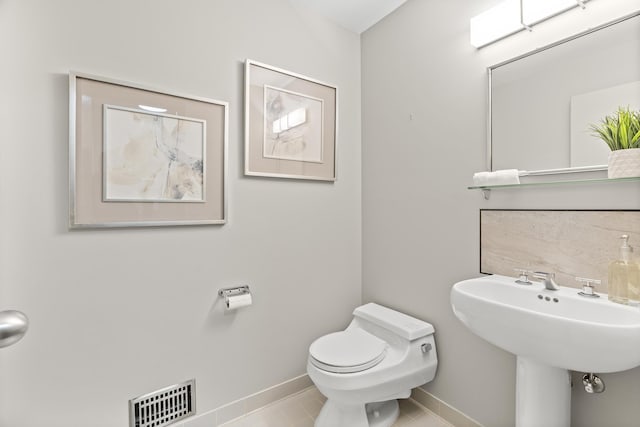 bathroom featuring tile patterned floors, visible vents, toilet, and baseboards