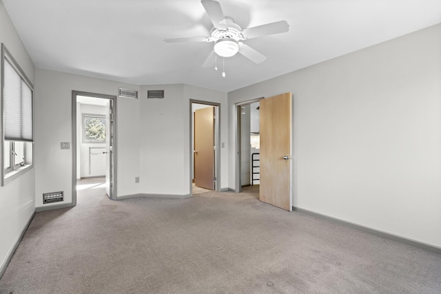 unfurnished bedroom with light colored carpet, visible vents, and baseboards