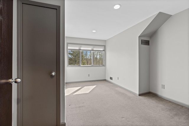 carpeted spare room with recessed lighting, baseboards, and visible vents