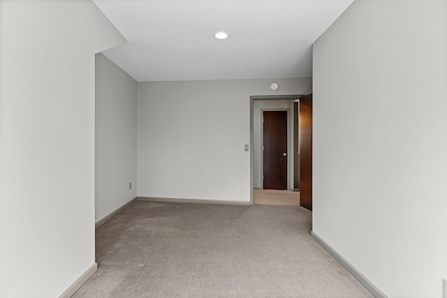 unfurnished room with baseboards and carpet