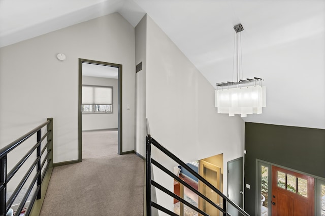 interior space with lofted ceiling, a healthy amount of sunlight, visible vents, and carpet floors