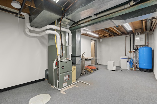 unfinished basement featuring heating unit and baseboards