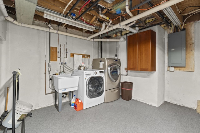 laundry room featuring laundry area, electric panel, independent washer and dryer, and a sink