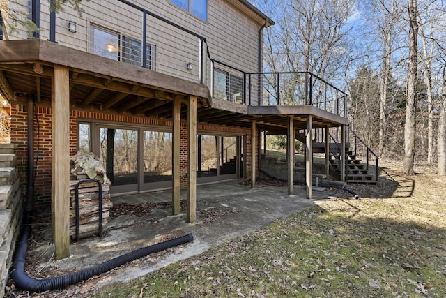 view of patio featuring stairs and a deck