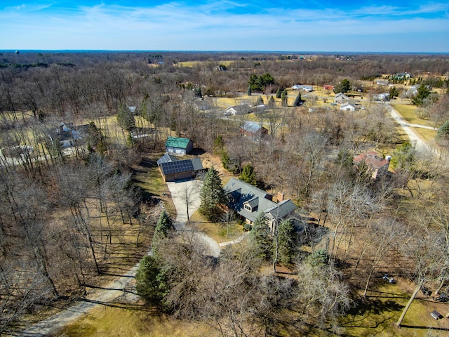 drone / aerial view with a wooded view