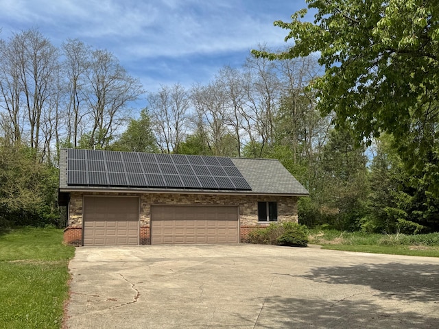 5557 N Territorial Rd, Ann Arbor, MI 48105 - garage with solar panels and driveway